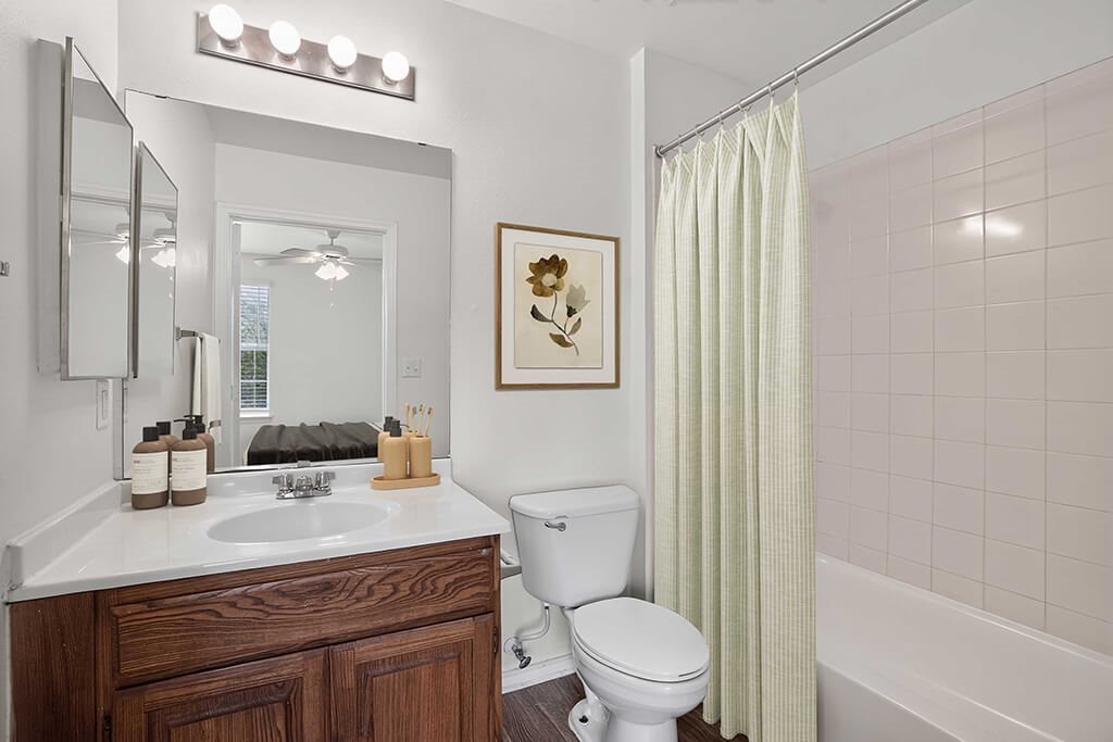 A white toilet sits next to a sink in a bathroom.